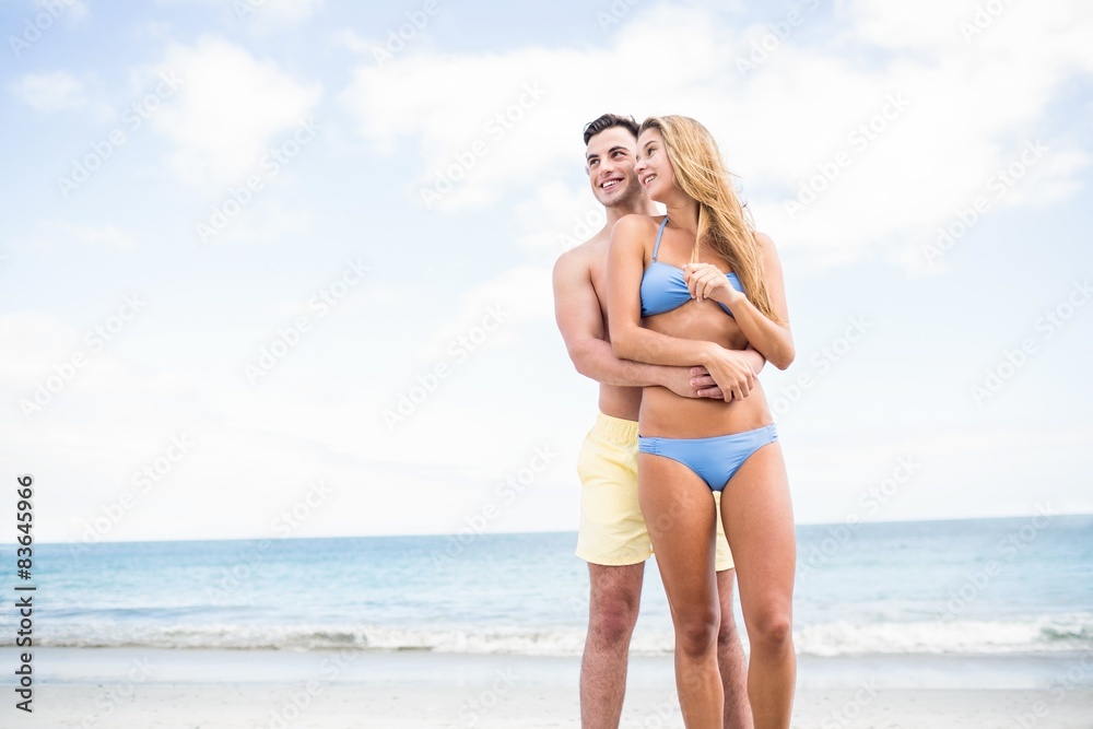 Happy couple in swimsuit embracing Happy couple in swimsuit embracing