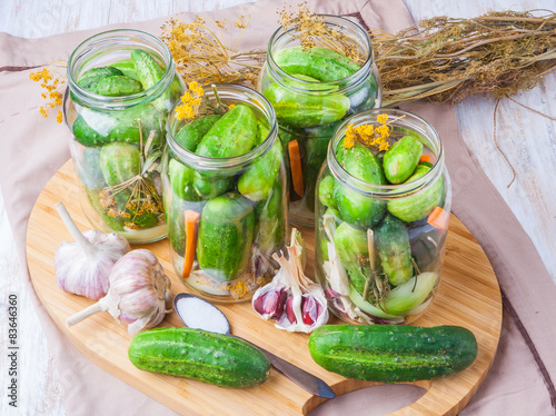 Jars of homemade preserves with pickled cucumbers