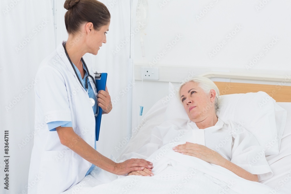 Doctor explaining report to female patient Doctor explaining report to female patient