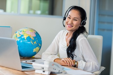 Pretty travel agent smiling at camera