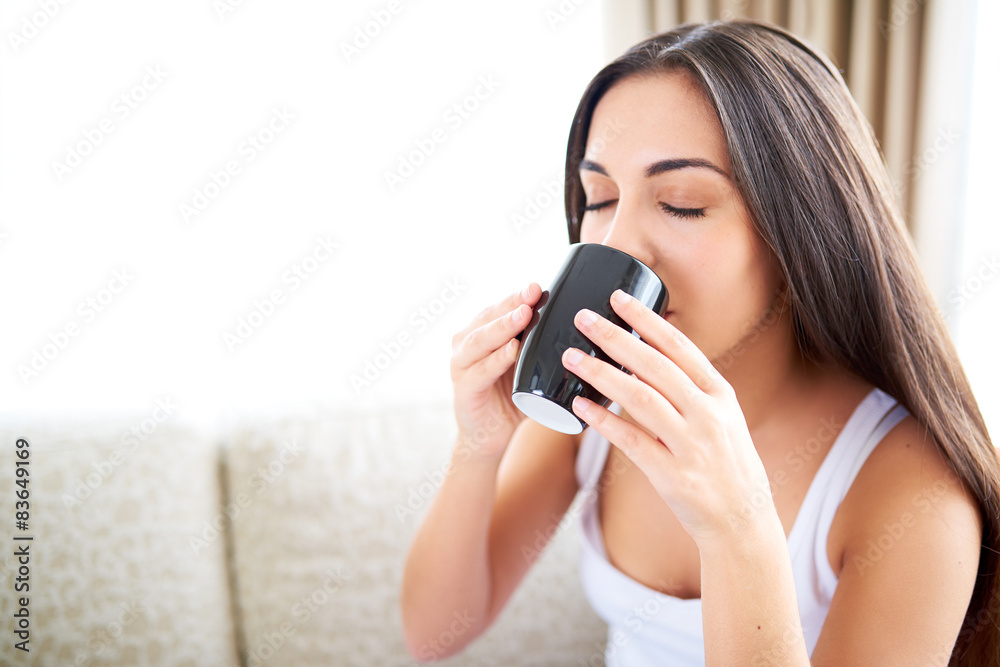 Close up of woman enjoying a warm drink. Close up of woman enjoying a warm drink.