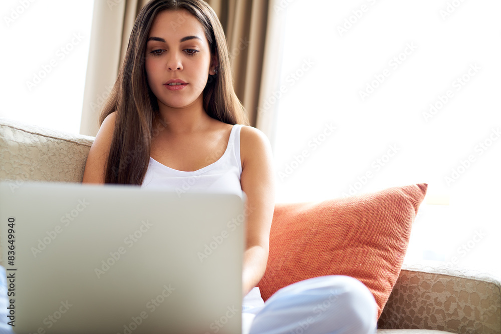 Pretty young woman relaxing with her laptop Pretty young woman relaxing with her laptop