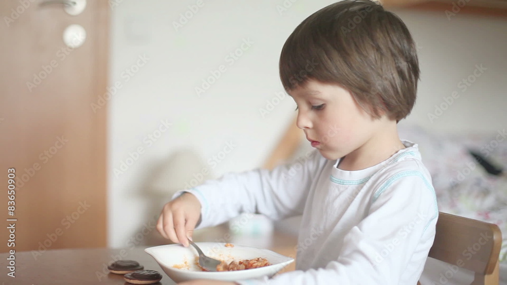 Cute little boy, watching TV and eating Cute little boy, watching TV and eating