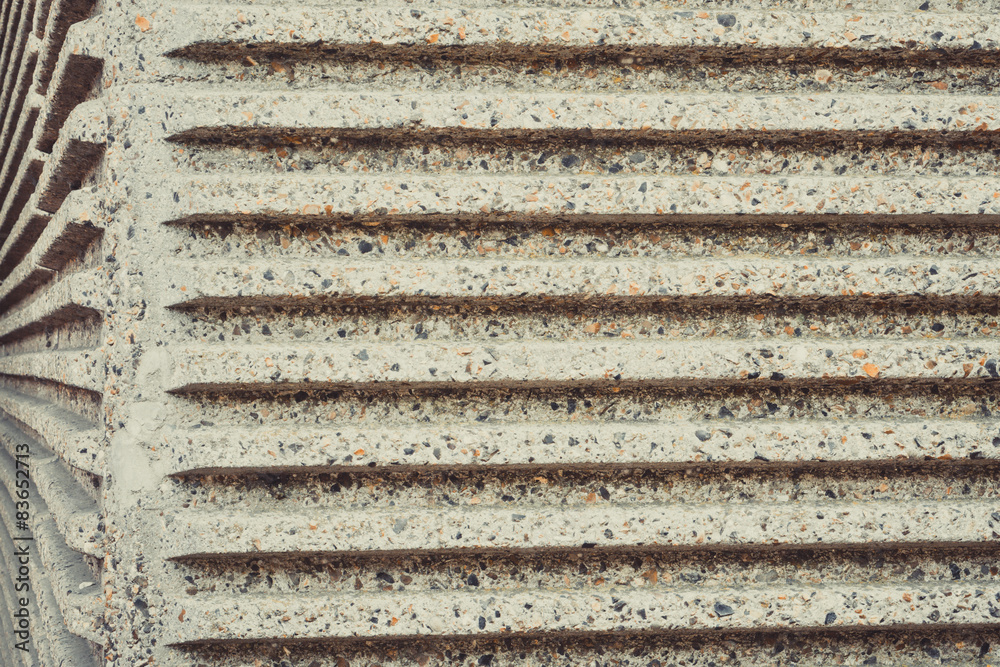 Parallel striped concrete wall of a bridge