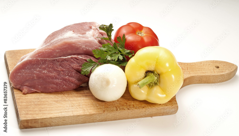 Raw fresh meat on board with condiments on white background Raw fresh meat on board with condiments on white background