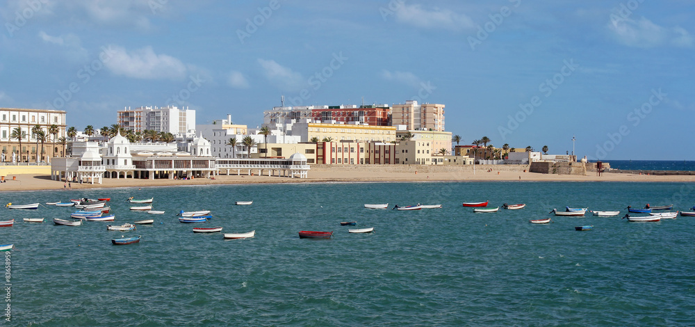 panoramic view of Caleta Beach and fishing boat in Cadiz, Spain