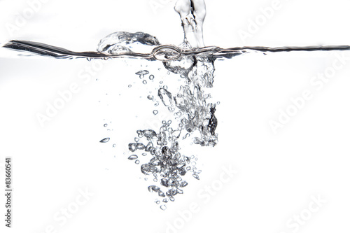 Flowing water and air bubbles over white background