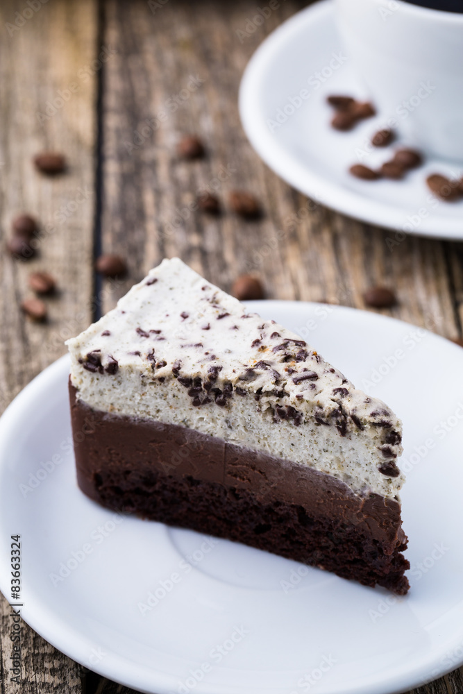 Chocolate dessert with coffee cup and coffee beans on wooden bac Chocolate dessert with coffee cup and coffee beans on wooden bac