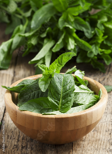 Fresh mint on an old wooden table, selective focus