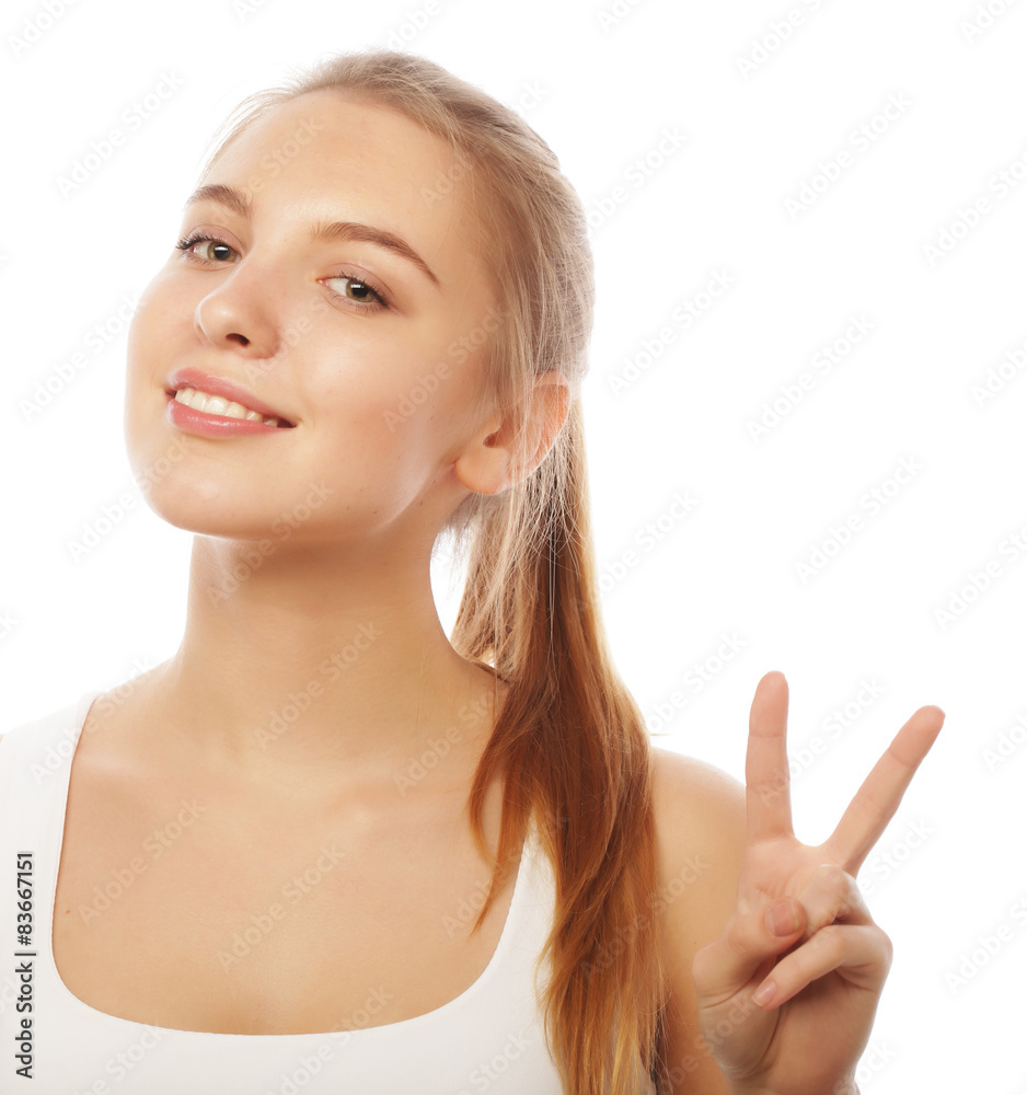 portrait of happy young woman giving peace sign portrait of happy young woman giving peace sign