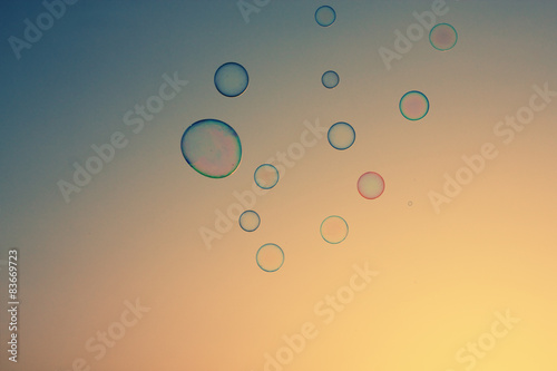 Soap bubbles floating in the air as the Summer sunsets photo