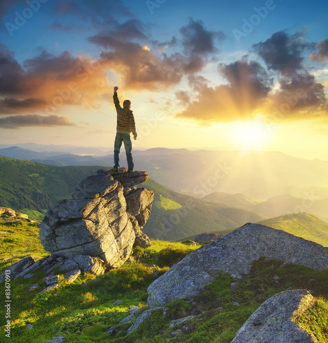 Silhouette of a champion on mountain peak. Active life concept