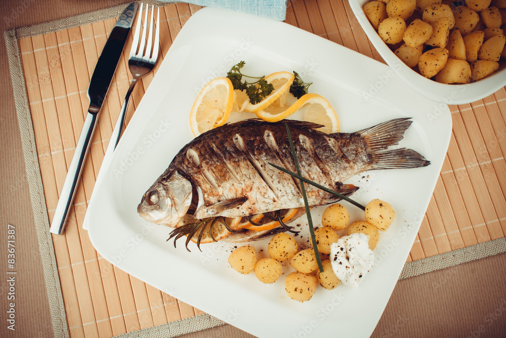 Grilled fish with rosemary potatoes and lemon Grilled fish with rosemary potatoes and lemon