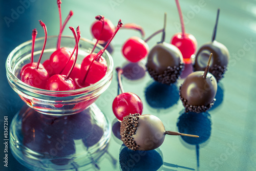 Chocolate and cocktail cherries on the glass photo