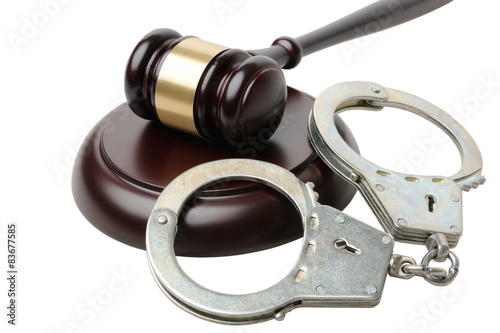Gavel and handcuffs on a white background
