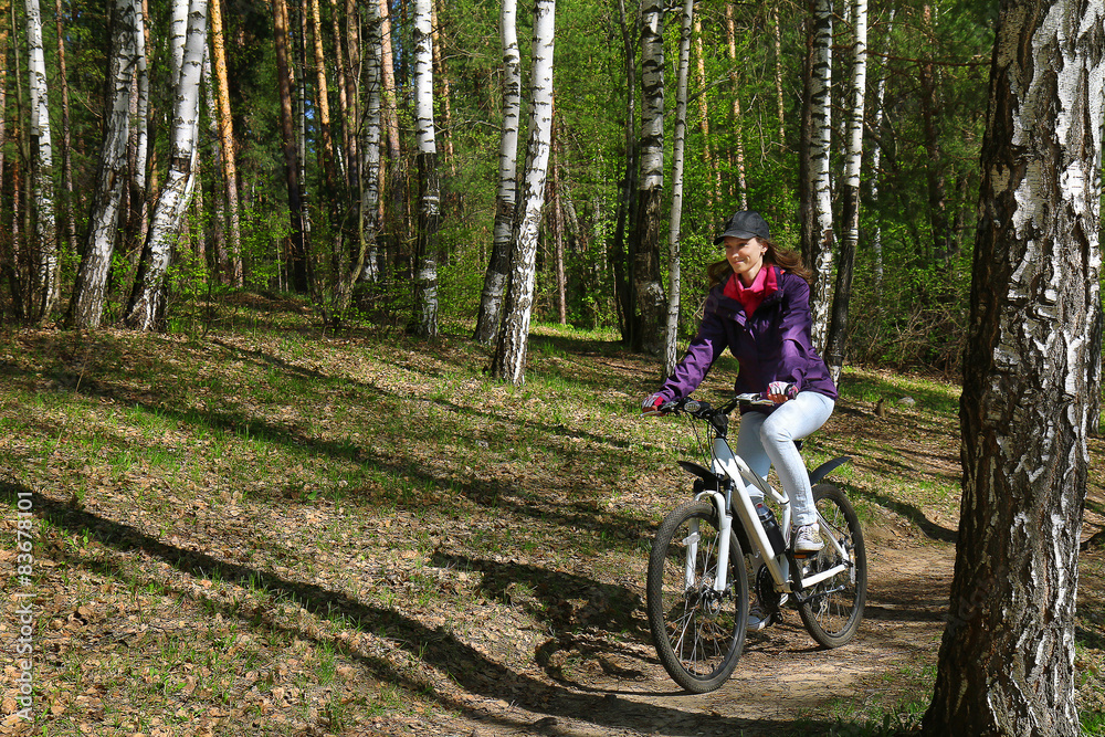 Bike riding - woman on bike in forest Bike riding - woman on bike in forest