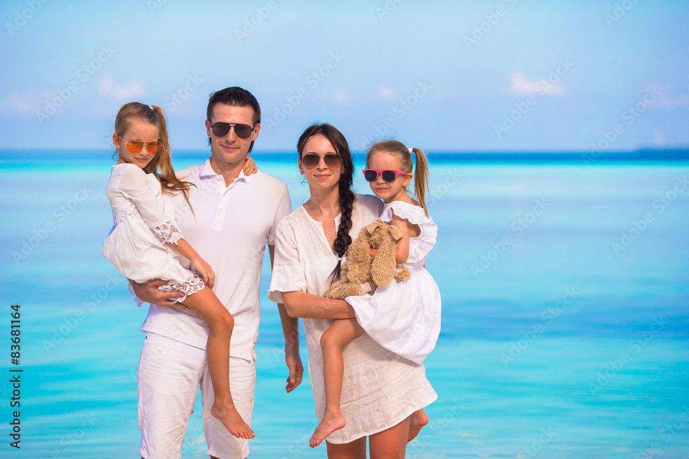 Young family of four on beach vacation Young family of four on beach vacation