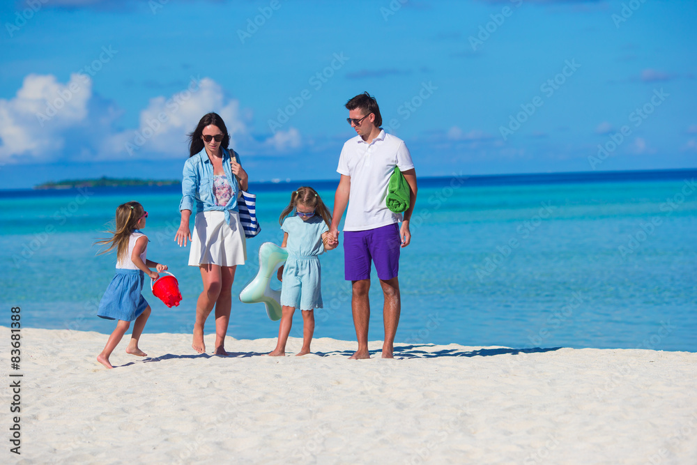 Young family of four on beach vacation