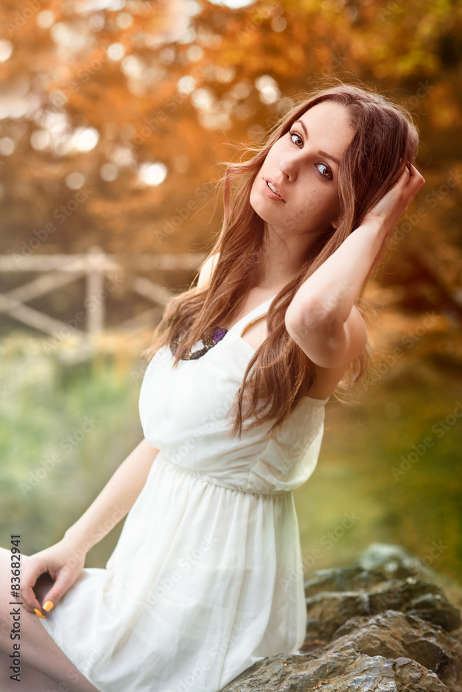 Beautiful woman in white dress in autumn forest Beautiful woman in white dress in autumn forest