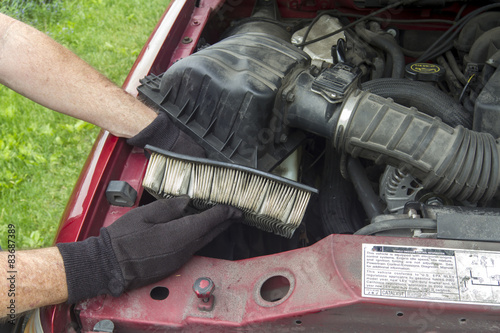  Mechanic Replacing A Dirty Air Filter In A Truck