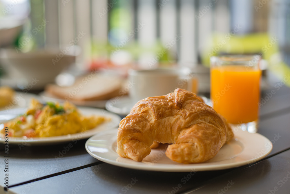 Croissant Breakfast served with black coffee and breakfast menu.