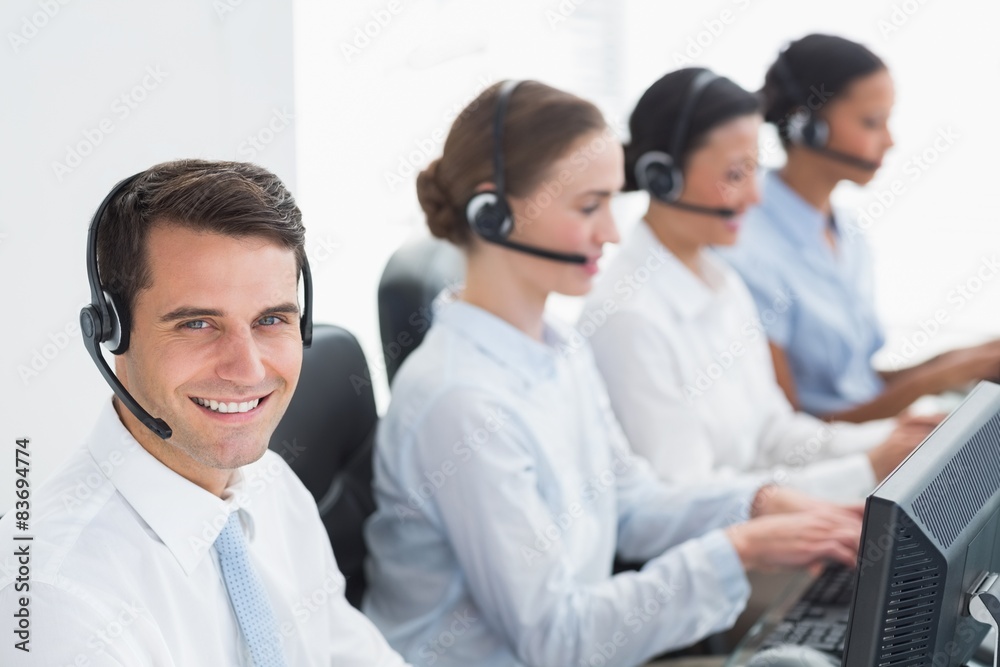 Business people with headsets using computers Business people with headsets using computers