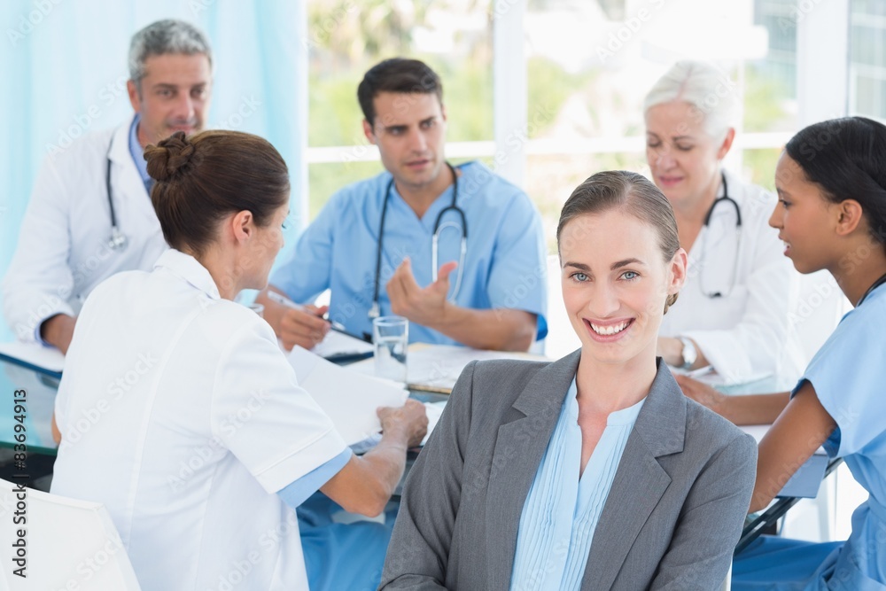 Male and female doctors working on reports