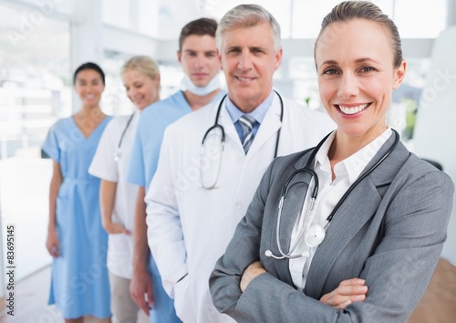 Smiling team of doctors standing in line