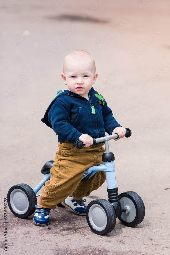Cute baby boy on his first running bike Cute baby boy on his first running bike
