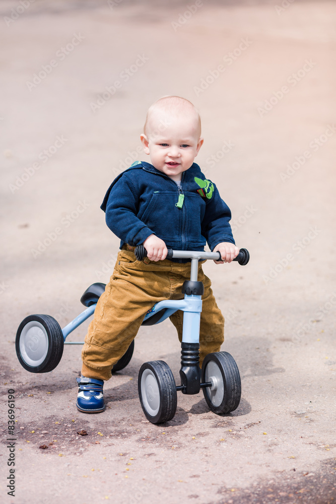 Cute baby boy on his first running bike Cute baby boy on his first running bike