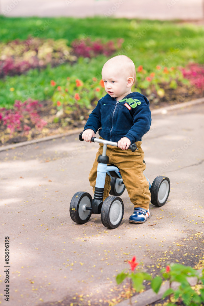 Cute baby boy on his first running bike Cute baby boy on his first running bike