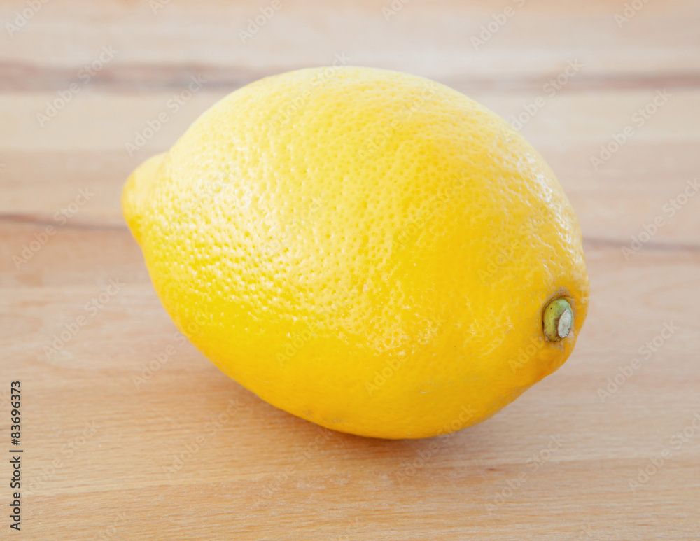 Yellow lemon on a wooden table