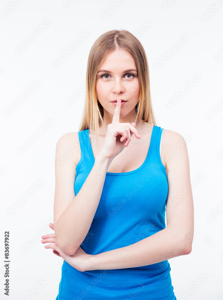 Young beautiful woman keeping finger on her lips Young beautiful woman keeping finger on her lips