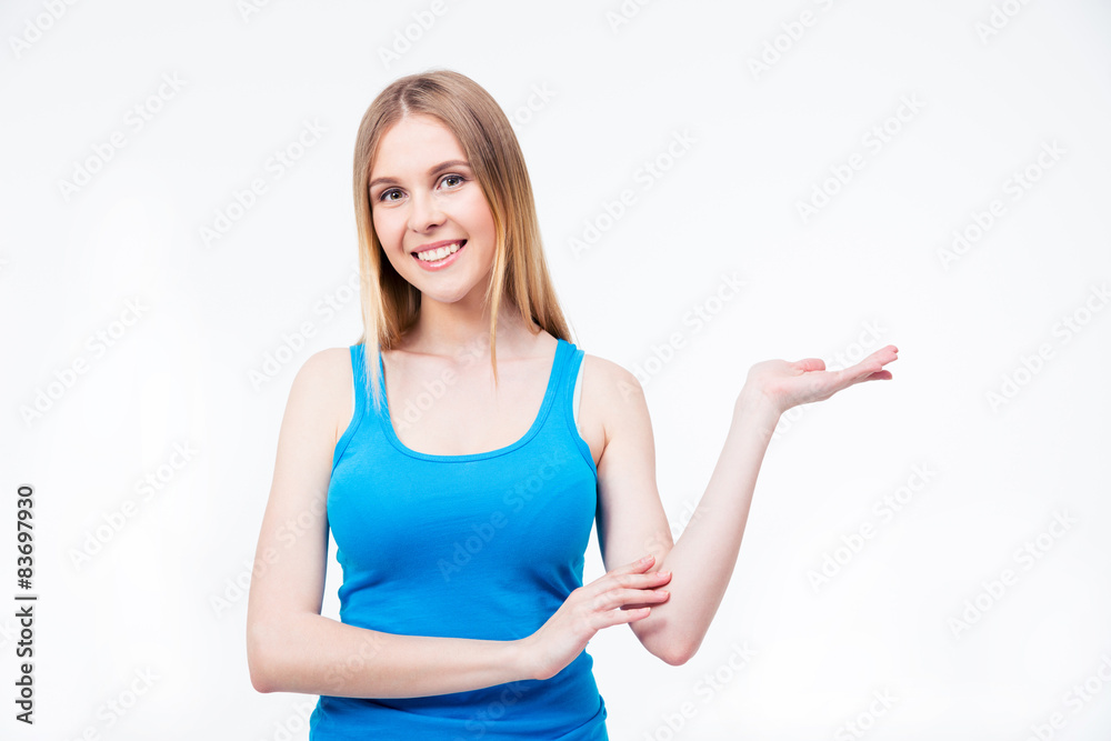 Happy young woman presenting something on the palm Happy young woman presenting something on the palm