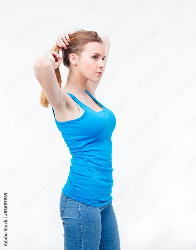 Young woman holding her hair in a ponytail Young woman holding her hair in a ponytail