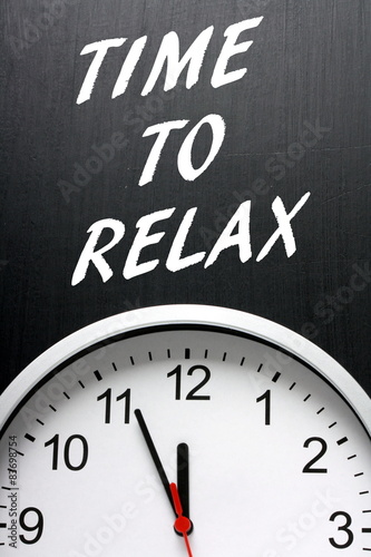 Time To Relax on a blackboard above a modern clock