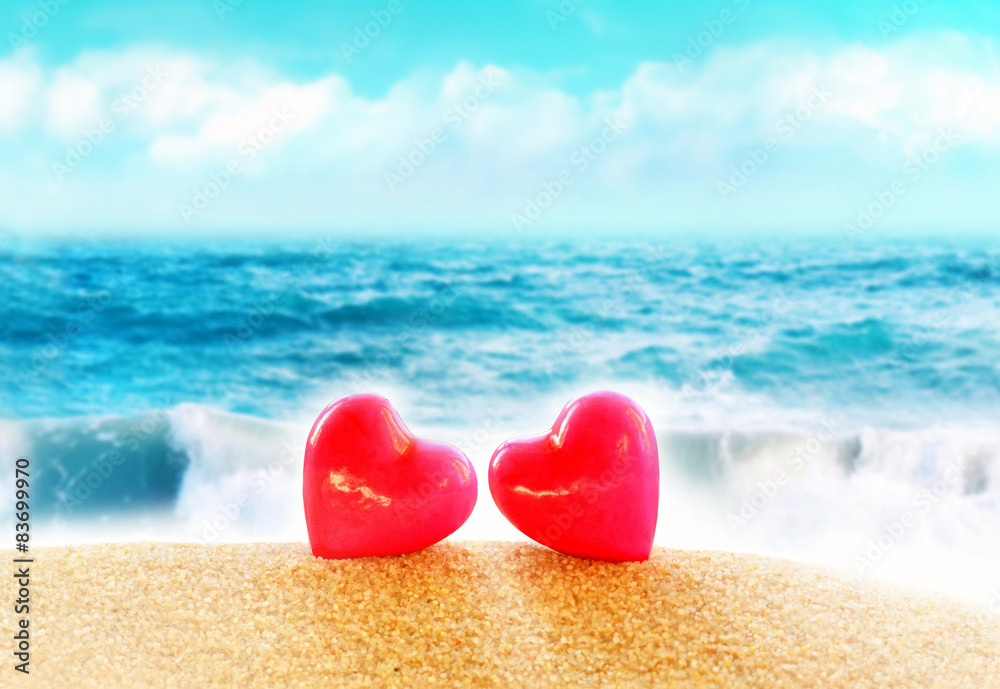 Fototapeta premium Summer beach. Two hearts on the sand.