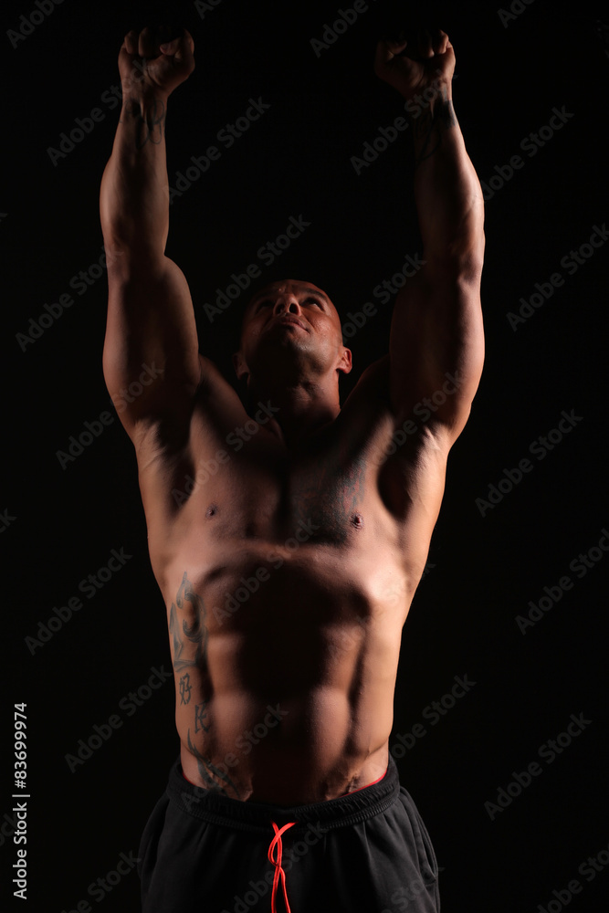 muscular bald man with his hands up muscular bald man with his hands up