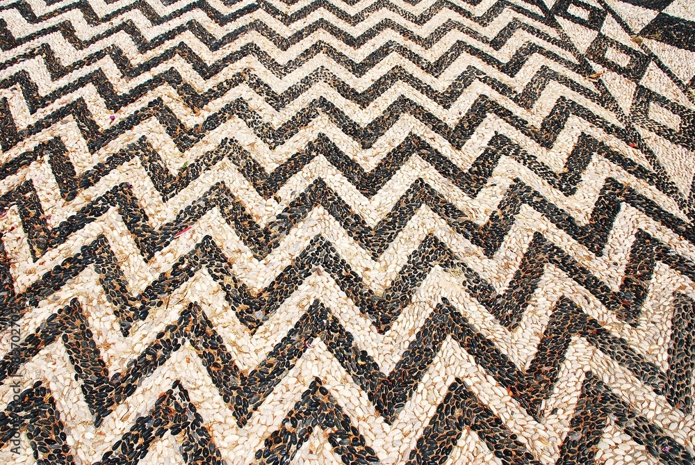 Pebble courtyard of Agios Nikolaos church at Emborio, Halki 