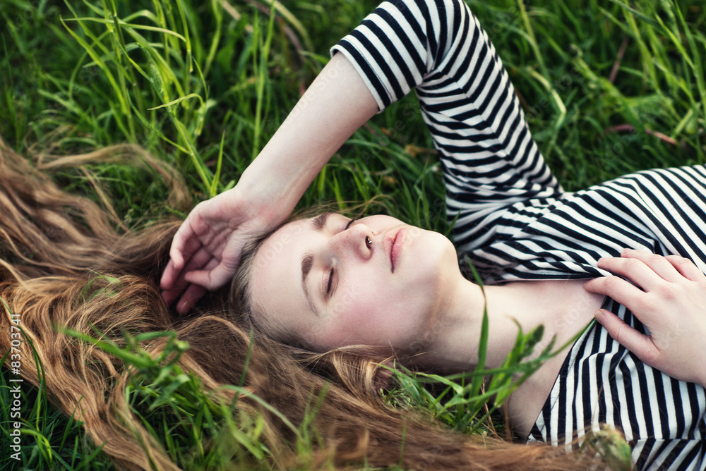 Beautiful young girl lying on the field Beautiful young girl lying on the field