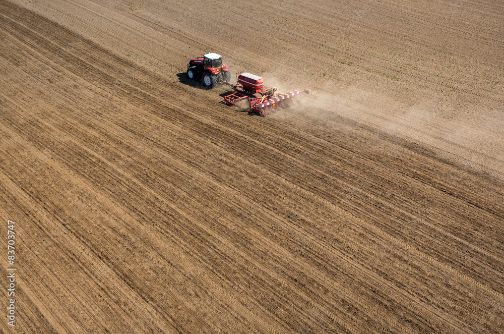 Aerial view of the tractor harrowing the field