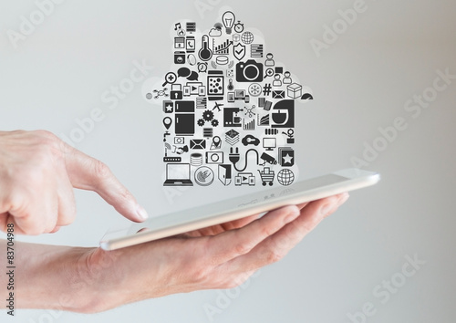 Hands holding tablet with smart home automation concept