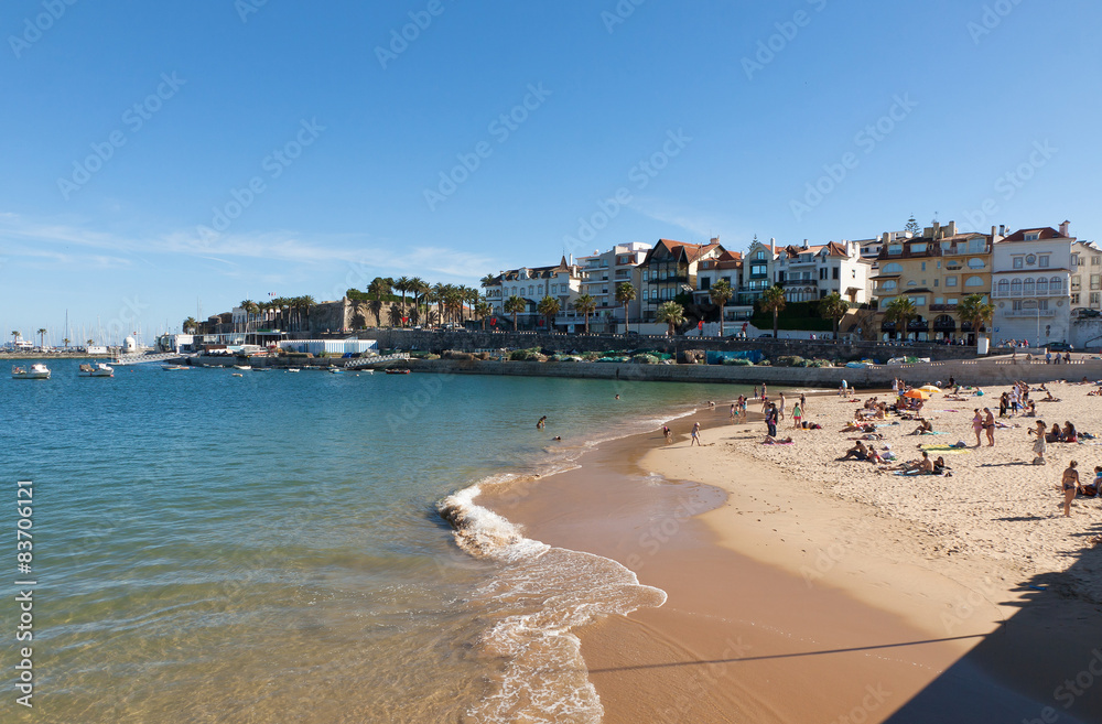 People sunbathing on the beach in Cascais, Portugal