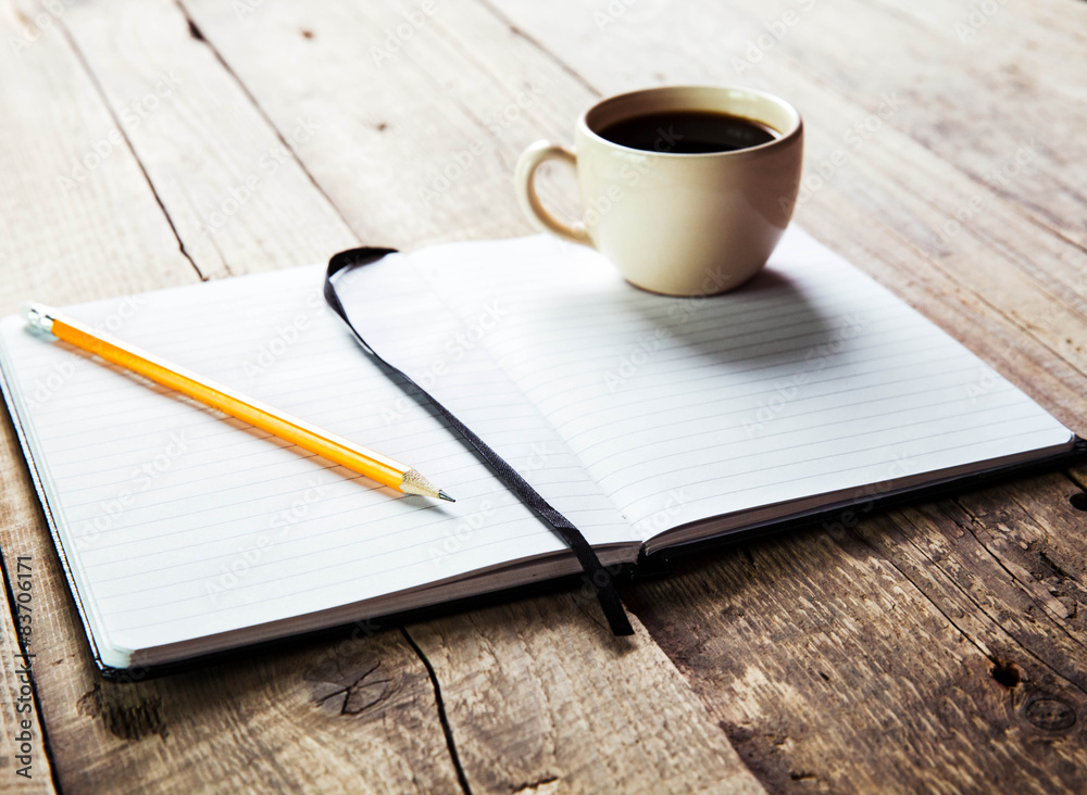 notebook pen and cup of coffee in wood table notebook pen and cup of coffee in wood table