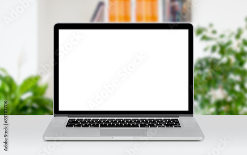 Laptop on table in office space mockup