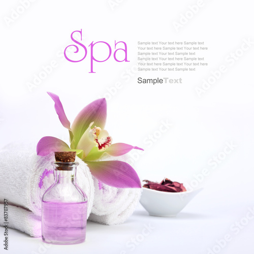Spa concept. Pink orchid, oil, potpourri and white towels.