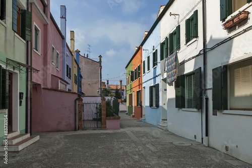 Colorful narrow street in Burano island, near Venice, Italy © vili45