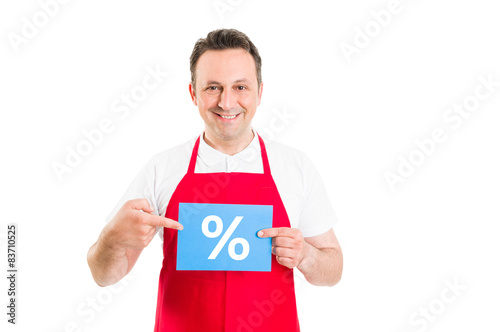 Friendly supermarket employee holding discount sign