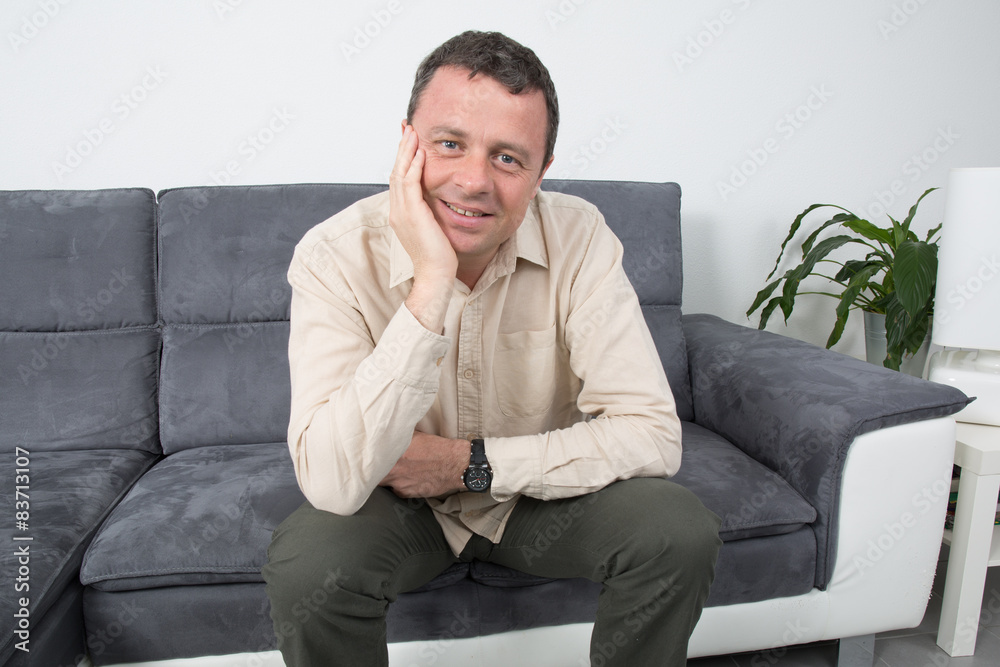 Handsome man relaxing on his sofa at home Handsome man relaxing on his sofa at home