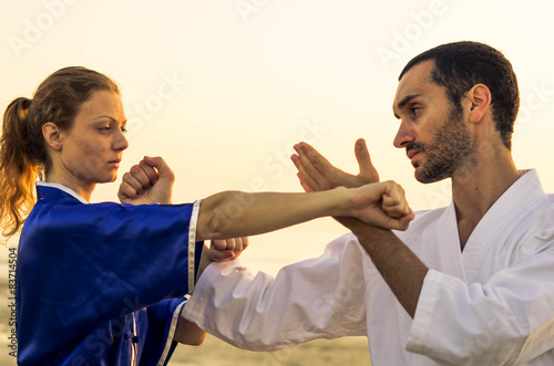 martial arts master challenge his pupil at the beach